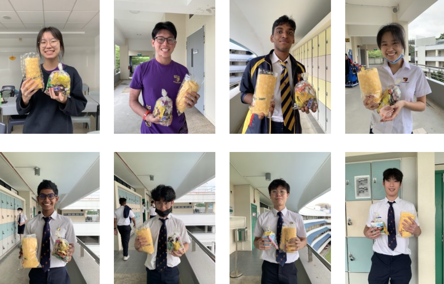 Eight students in school uniforms smile while holding clear bags filled with yellow snacks and candy at school.